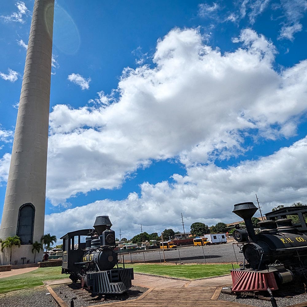 image of historic smokestack and trains in Lahaina.